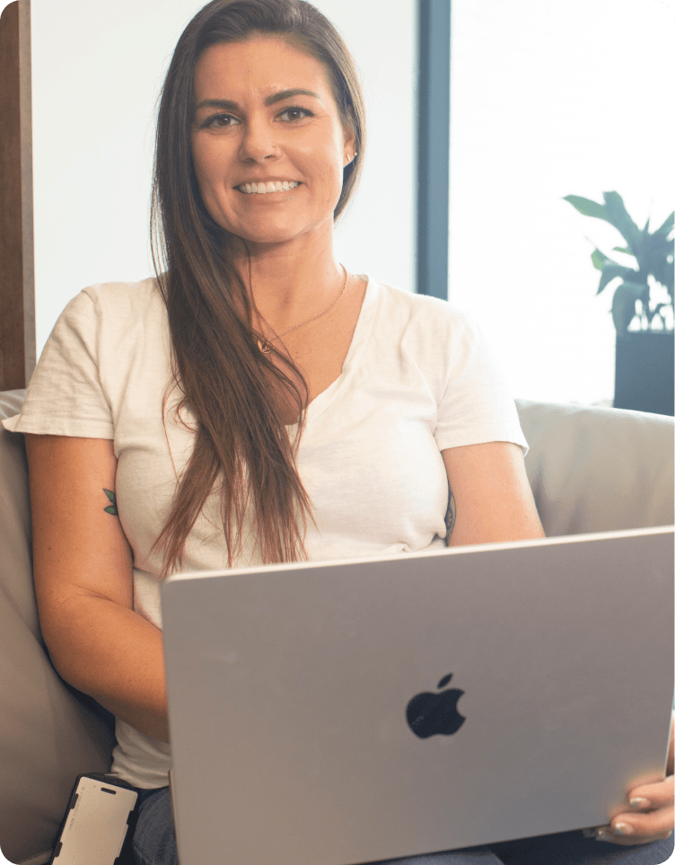 Stacey Best seated with her laptop